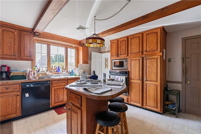 kitchen with brown cabinets, beam ceiling, black appliances, and light floors