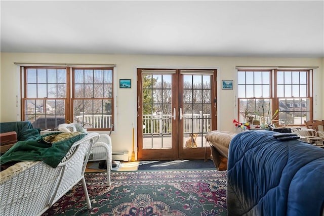 doorway with french doors and a baseboard heating unit