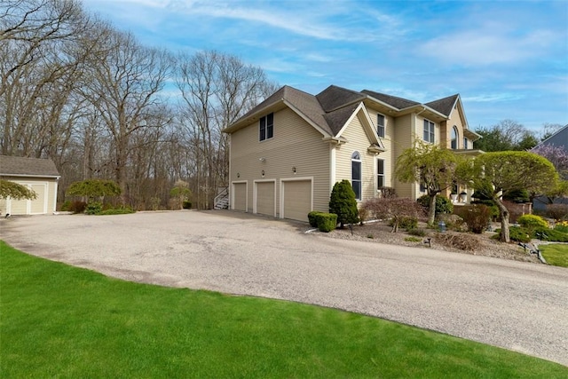 174 Windmill Dr, South Kingstown, RI 02879 - view of side of property with an attached garage and driveway