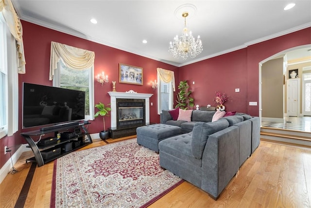 174 Windmill Dr, South Kingstown, RI 02879 - living room with crown molding, arched walkways, recessed lighting, and wood finished floors