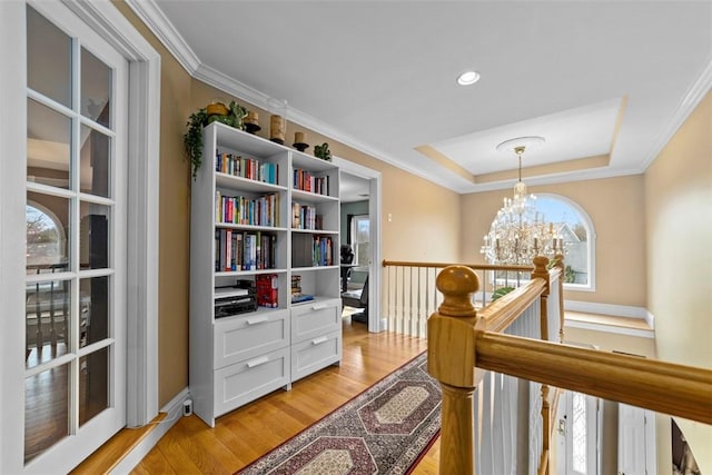 174 Windmill Dr, South Kingstown, RI 02879 - corridor featuring crown molding, a notable chandelier, an upstairs landing, and light wood-style floors