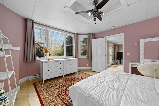 174 Windmill Dr, South Kingstown, RI 02879 - bedroom with ceiling fan, baseboards, a drop ceiling, light tile patterned floors, and a baseboard heating unit