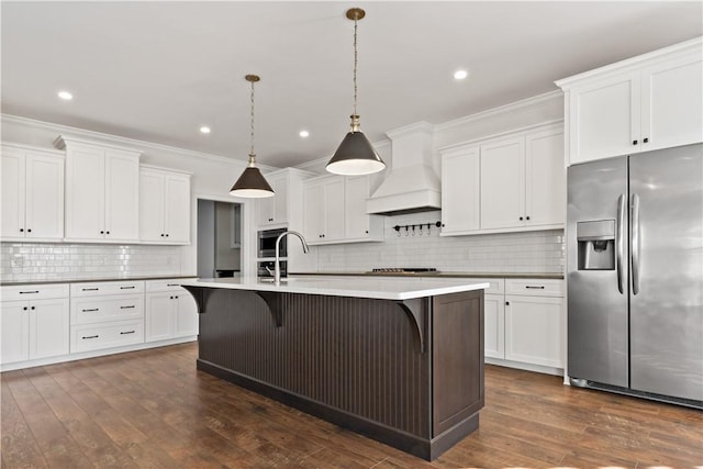 kitchen featuring custom exhaust hood, decorative backsplash, recessed lighting, and stainless steel appliances