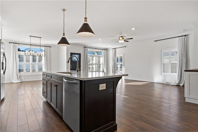 kitchen featuring a sink, open floor plan, plenty of natural light, and ceiling fan with notable chandelier