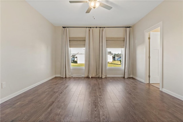empty room featuring hardwood / wood-style flooring, baseboards, and ceiling fan