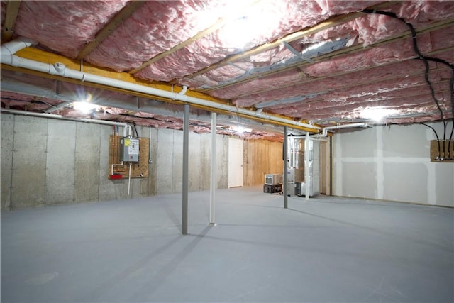 unfinished basement with water heater and heating unit