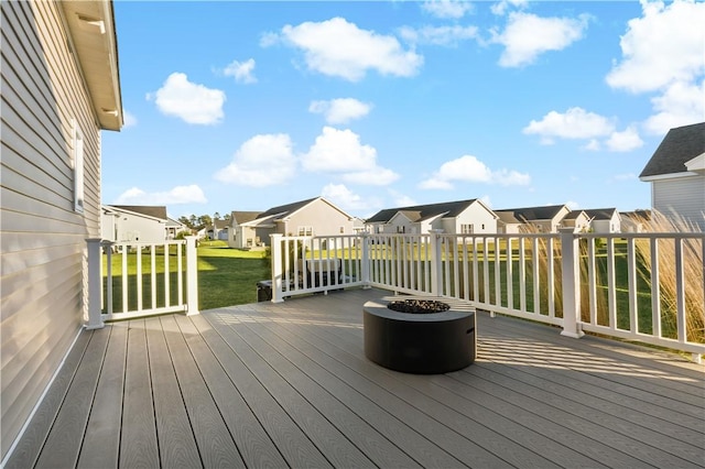 wooden deck featuring a yard and a residential view