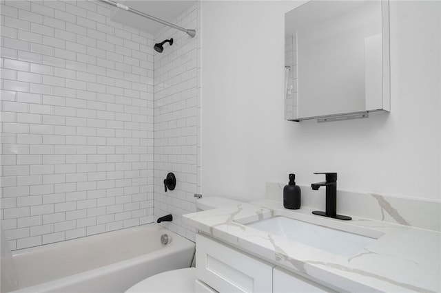 bathroom with toilet, vanity, and shower / washtub combination
