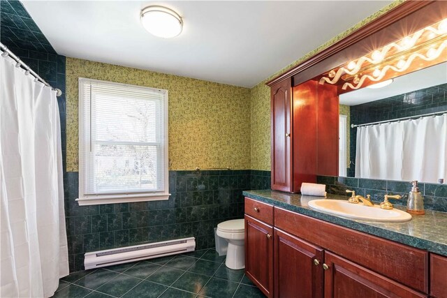 full bathroom with a baseboard heating unit, toilet, tile walls, tile patterned floors, and vanity