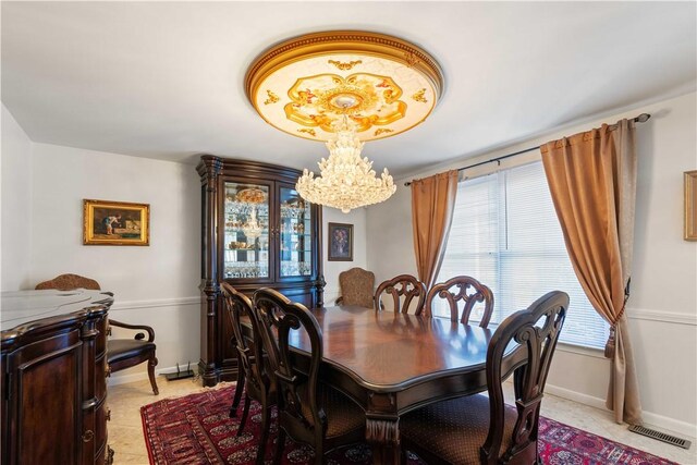 dining space with baseboards, visible vents, and an inviting chandelier