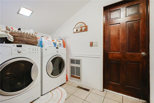 clothes washing area featuring light tile patterned flooring, visible vents, laundry area, and washing machine and dryer