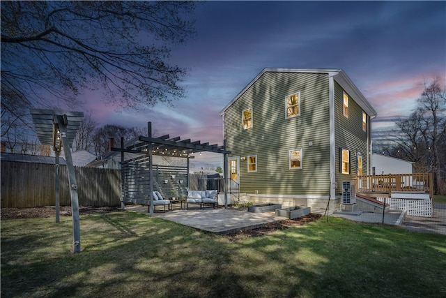 rear view of property with a pergola, a lawn, a patio, fence, and a deck