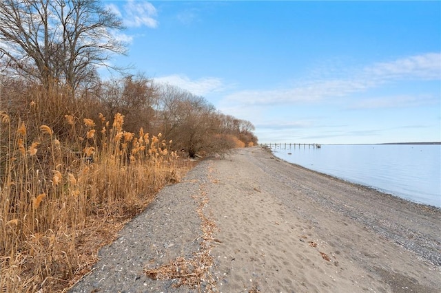 exterior space featuring a view of the beach and a water view