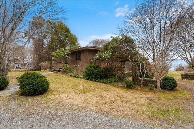 view of side of property with a lawn