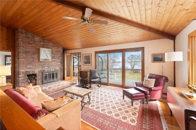 living room featuring wooden ceiling, a brick fireplace, lofted ceiling with beams, a ceiling fan, and wood finished floors