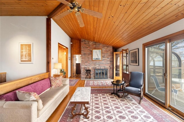 living room with wooden ceiling, a ceiling fan, a fireplace, wood finished floors, and lofted ceiling