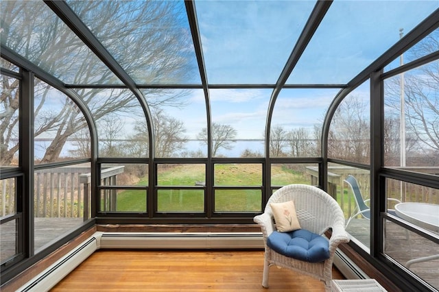 unfurnished sunroom with a baseboard heating unit