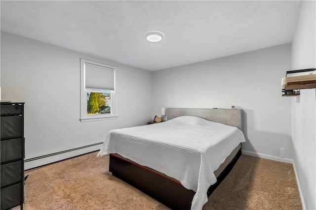 bedroom featuring a baseboard heating unit, baseboards, and carpet flooring