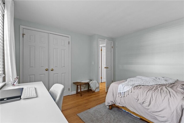 bedroom featuring a closet and wood finished floors