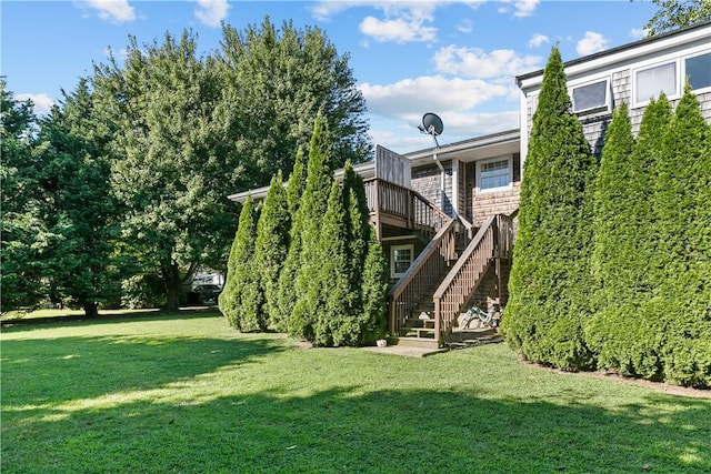 view of yard featuring stairs and a deck