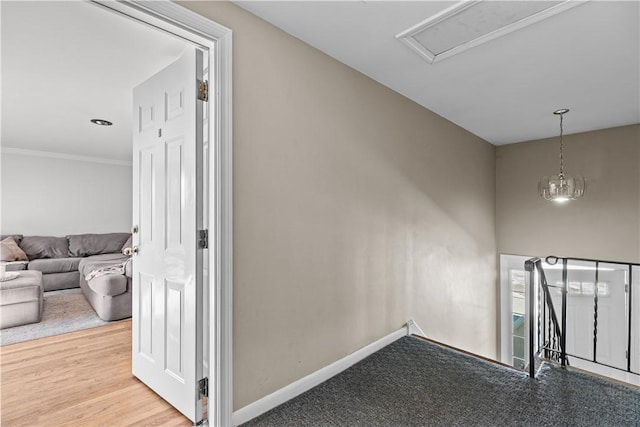 corridor featuring baseboards and ornamental molding