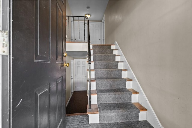 staircase featuring baseboards