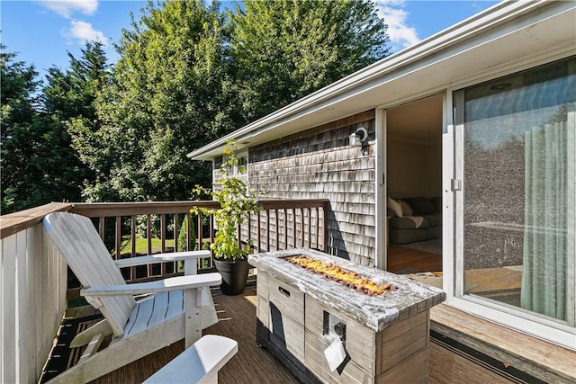 wooden terrace with an outdoor fire pit