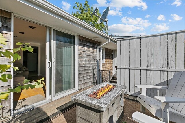 balcony featuring an outdoor fire pit