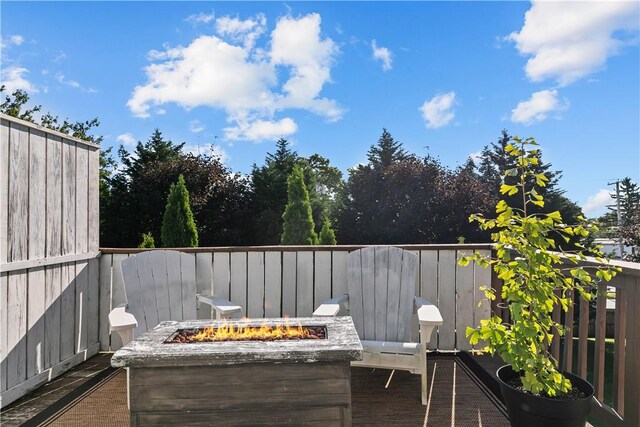 view of patio / terrace featuring fence and a fire pit