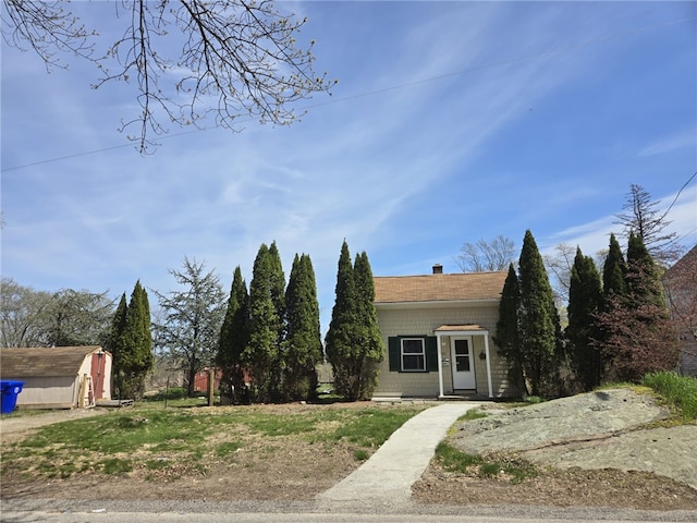 25 Wilson St, West Warwick, RI 02893 - view of front facade with a storage shed, a chimney, and an outdoor structure