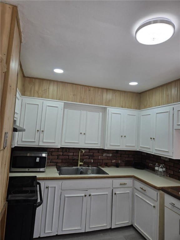 25 Wilson St, West Warwick, RI 02893 - kitchen featuring stainless steel microwave, light countertops, white cabinets, electric range oven, and a sink