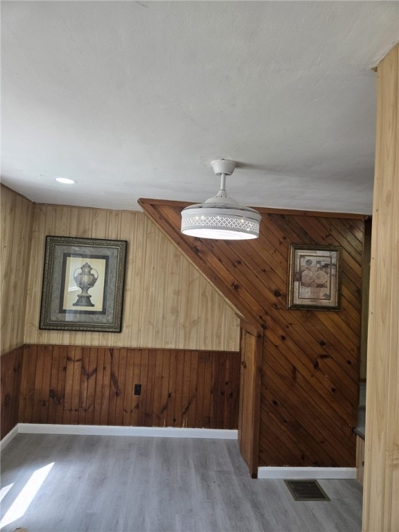 25 Wilson St, West Warwick, RI 02893 - bonus room with wooden walls, visible vents, wood finished floors, and baseboards