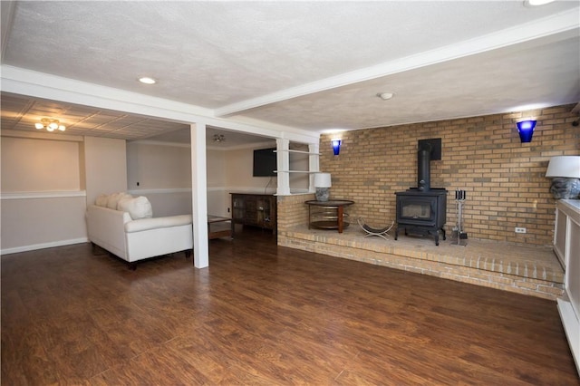67 Highwood Dr, Coventry, RI 02816 - living room with recessed lighting, baseboards, brick wall, wood finished floors, and a wood stove