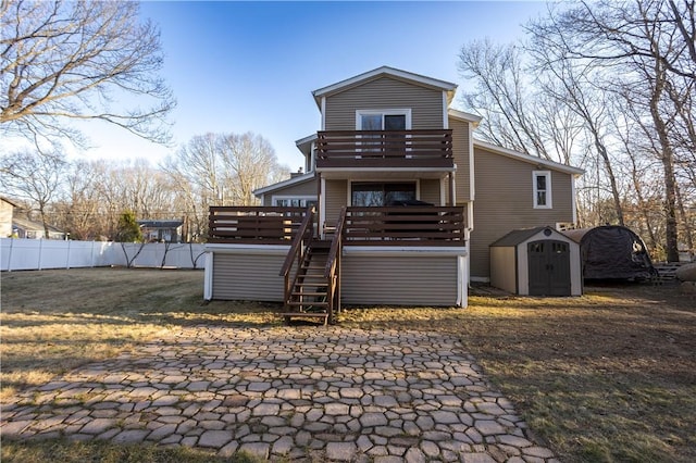67 Highwood Dr, Coventry, RI 02816 - rear view of property featuring a balcony, fence, an outdoor structure, stairs, and a storage shed