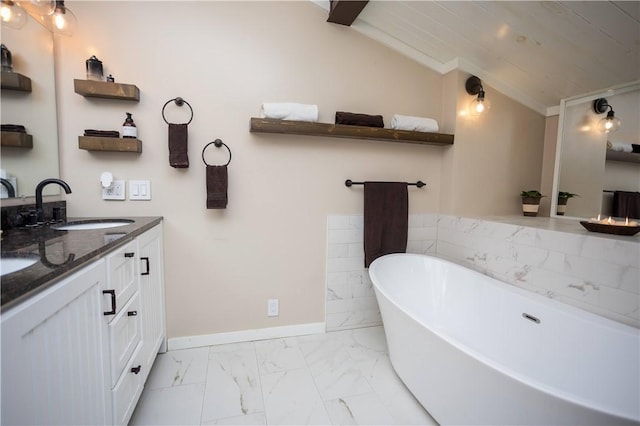 67 Highwood Dr, Coventry, RI 02816 - bathroom with baseboards, marble finish floor, vanity, a freestanding bath, and vaulted ceiling