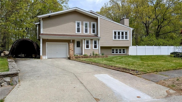 67 Highwood Dr, Coventry, RI 02816 - split level home with an attached garage, a chimney, fence, concrete driveway, and a front yard