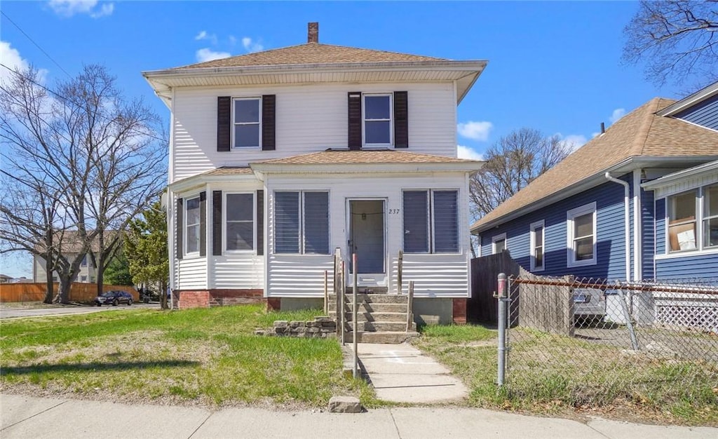 american foursquare style home with roof with shingles, entry steps, fence, and a chimney
