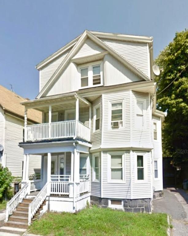 view of front of house with a balcony, covered porch, and cooling unit