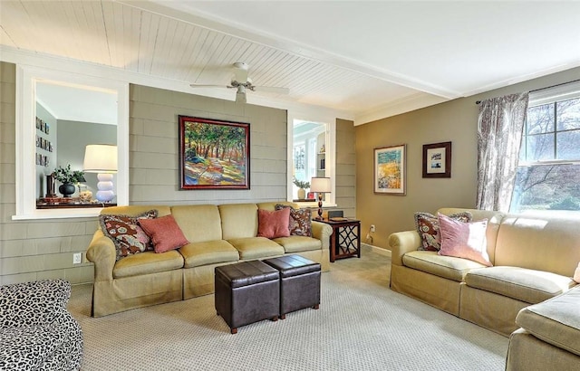 carpeted living area with ceiling fan