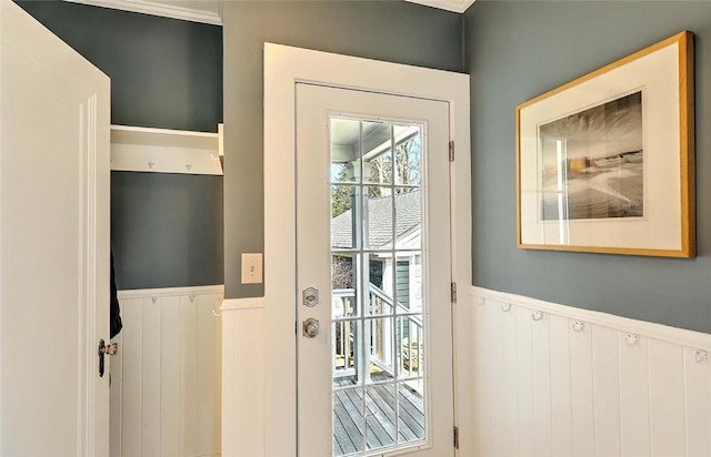 entryway featuring a decorative wall and a wainscoted wall