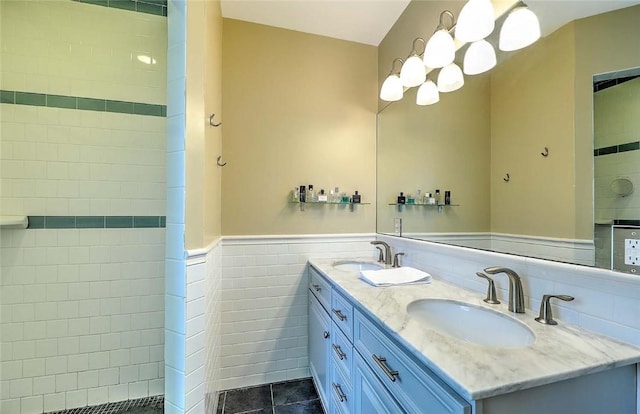bathroom with a sink, tile walls, a wainscoted wall, and double vanity