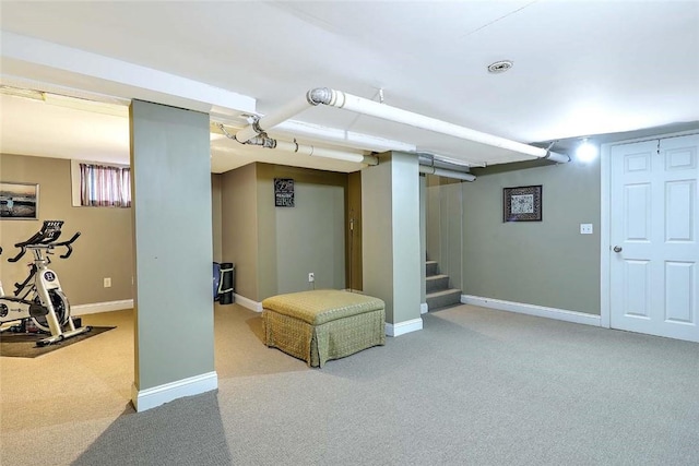 finished basement featuring stairs, baseboards, and carpet floors