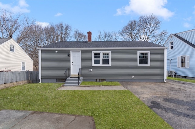 43 Eldorado St, Cranston, RI 02910 - bungalow-style home featuring entry steps, a front yard, fence, a chimney, and a shingled roof