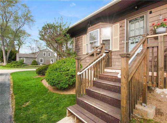 doorway to property featuring a yard