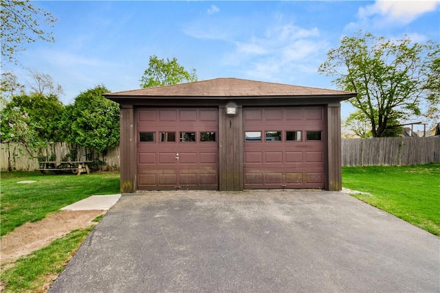 detached garage featuring fence