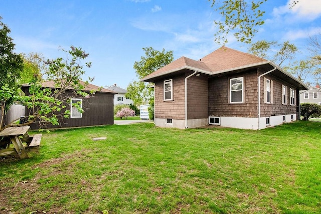 rear view of house with a yard
