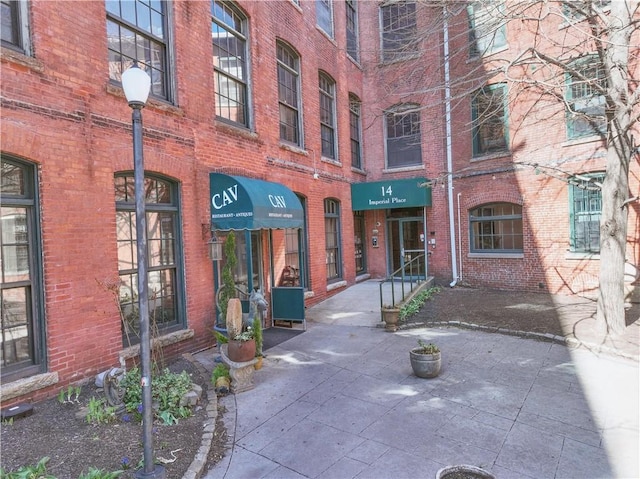 view of exterior entry featuring brick siding
