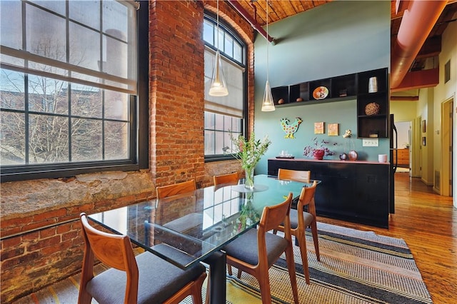 dining space featuring wood-type flooring, high vaulted ceiling, plenty of natural light, and wood ceiling