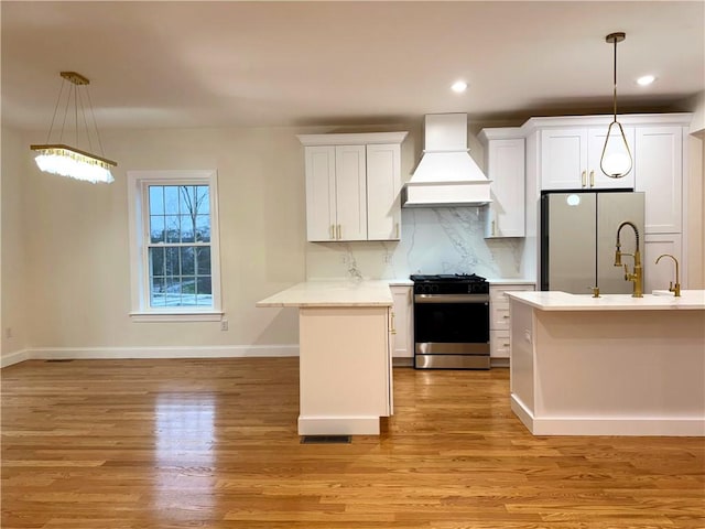 1404 Hunting Hill Dr, Cumberland, RI 02864 - kitchen featuring stainless steel appliances, light wood finished floors, light countertops, custom range hood, and baseboards