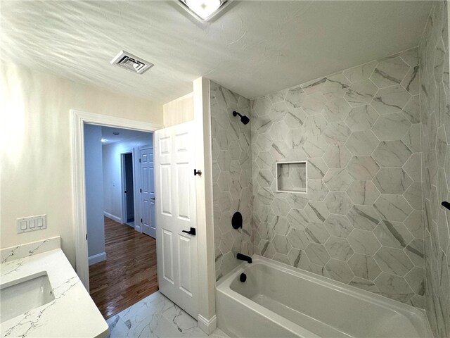 1404 Hunting Hill Dr, Cumberland, RI 02864 - bathroom with baseboards, visible vents, marble finish floor, vanity, and tub / shower combination